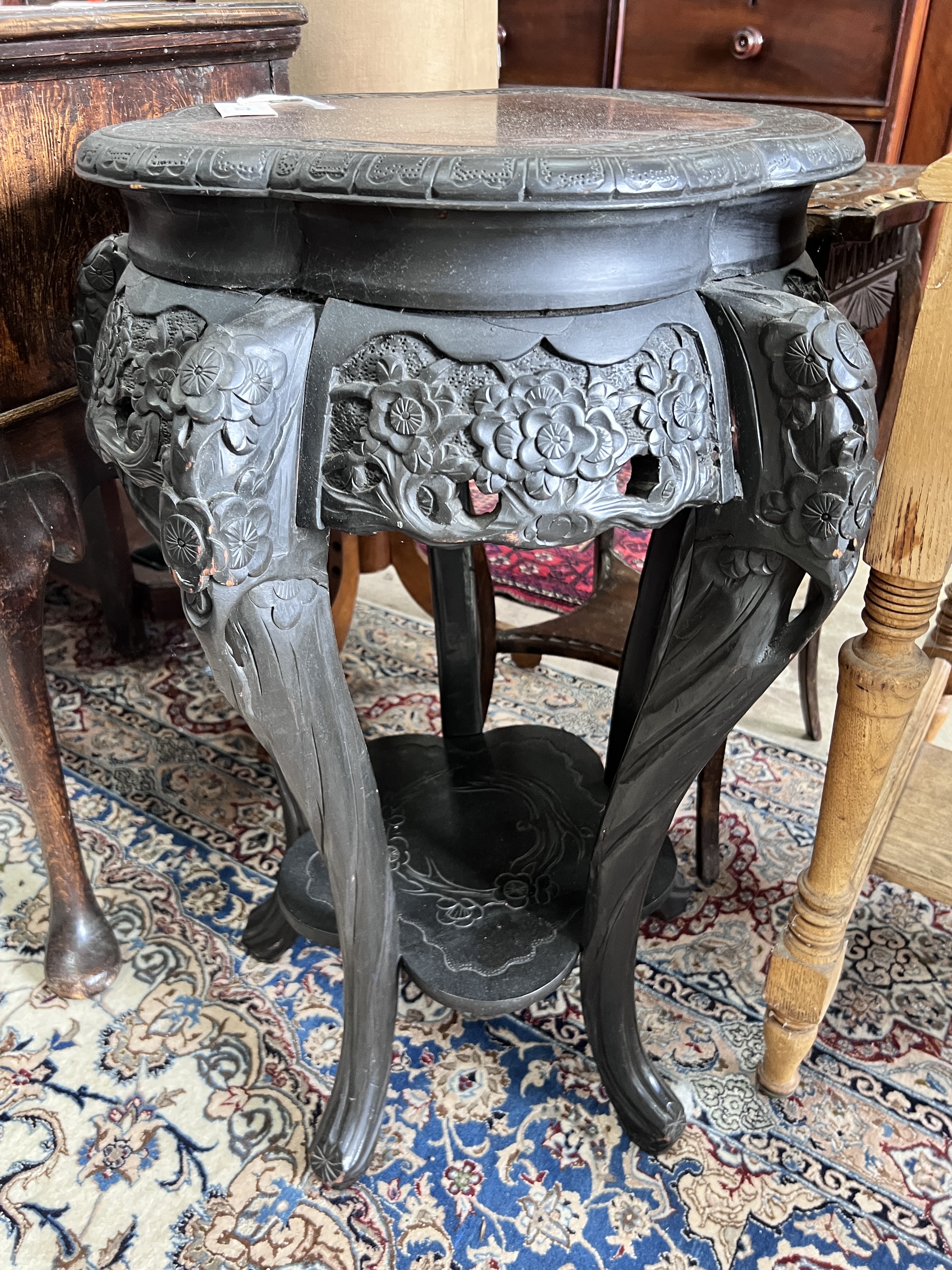 A Chinese carved two tier jardiniere stand, width 54cm, height 78cm, together with a carved beech oak two tier occasional table